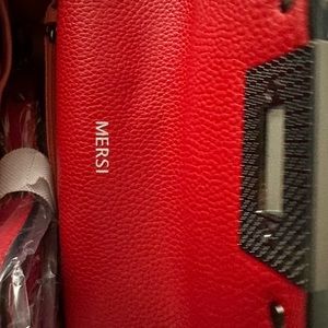 Small red leather studded handbag.